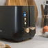 Two-slice grey toaster with bagels toasting, angled top view