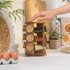 Wooden spice rack with twelve glass jars and wooden lids, plus one empty jar beside.