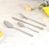 Set of four stainless steel cutlery pieces on marble surface