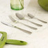Four-piece stainless steel cutlery set on marble worktop