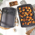 Grey non-stick roasting tin, rectangular, shown from the side.