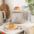 Taupe toaster with bun rack and kettle on kitchen worktop