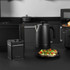Matte black electric kettle on kitchen counter, part of Salter appliance set.