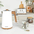 White electric kettle with wood-effect handle on kitchen counter