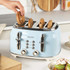 Light blue 4-slice toaster on kitchen counter with bagels, hand placing one in slot