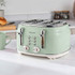 Pale green four-slice toaster with chrome details, shown on a kitchen counter.