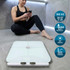 White digital bathroom scale with body metrics features, shown in use by woman after workout.