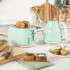 Mint green toaster and kettle set on kitchen counter, showing two slices of toast.