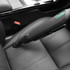 Cordless handheld vacuum cleaning car seat, close-up shows slim nozzle in use