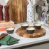Set of four grey ramekins with baked custards on a kitchen counter