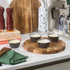 Set of four grey ramekins with baked custards on a kitchen counter