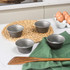 Set of four grey non-stick pudding moulds on kitchen worktop, suitable for baking
