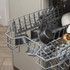 Grey ceramic bowls in dishwasher top rack, kitchen cleaning use