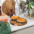 Two baked pies with golden crusts on a wooden board in a kitchen setting