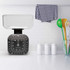Black analogue kitchen scale with clear bowl on countertop