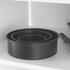 Set of three round black baking tins nested together on a kitchen shelf