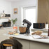 Black and wood-effect stand mixer packaging showing attachments and key features.