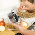 Manual onion chopper in use on kitchen worktop with chopped onions shown