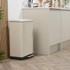 Cream pedal bin with black base in modern kitchen setting