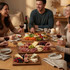 Lifestyle image of friends sharing wine and charcuterie boards on dining table