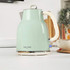 Pastel green electric kettle with cream handle on kitchen worktop