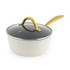 Cream saucepan with a glass lid and gold handle, angled side view