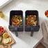 Grey dual basket air fryer on kitchen counter, filled with roasted vegetables.