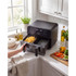 Large black digital air fryer on kitchen counter with cooked chips in basket