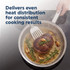 Set of stainless steel saucepans on hob, each cooking different food, kitchen setting