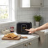 Black digital toaster with touchscreen controls on kitchen counter
