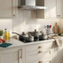 Grey saucepan and casserole set on hob in modern kitchen, showing cookware style and layout