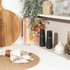 Black electric salt or pepper grinder on kitchen shelf