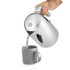 Chrome electric kettle pouring hot water into grey mug