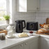 Black Salter kettle and toaster on kitchen counter beside bread and pastries