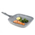 Square grey non-stick grill pan with cooked salmon, broccoli, and lemon half