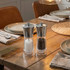 Pair of silver salt and pepper grinders on a dining table setting