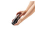 Manual black and clear salt or pepper grinder held in both hands, showing grinding action