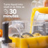 Grey frozen dessert maker on kitchen worktop, fruit bowl and cutting board nearby
