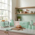 Mint green kitchen set with toaster, kettle, bread bin, and canisters on a counter