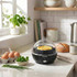 Black electric egg cooker with omelette, on kitchen worktop