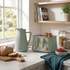 Salter sage green kettle and toaster set with bread and fruit on kitchen counter