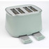 Sage green 4-slice toaster with two open crumb trays, shown from a side angle