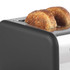 Grey toaster with two slices of seeded bread toasting, shown close up