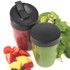 Two blender cups with black lids, one with red smoothie, one with green smoothie, fresh fruit beside.