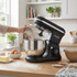 Stainless steel mixer beater attachment on white background