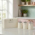 Cream bread bin and three labelled kitchen storage canisters on countertop