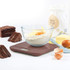 Brown digital kitchen scale with baking ingredients and chocolate cake slices