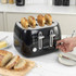 Black 4-slice toaster with bread slices, showing a person adjusting control knob