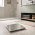 Silver digital bathroom scale on tiled floor