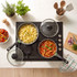 Overhead view of two pans cooking pasta and tomato sauce on a kitchen hob, for cookware listing